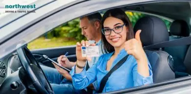 Woman showing id card while in a car with instructor