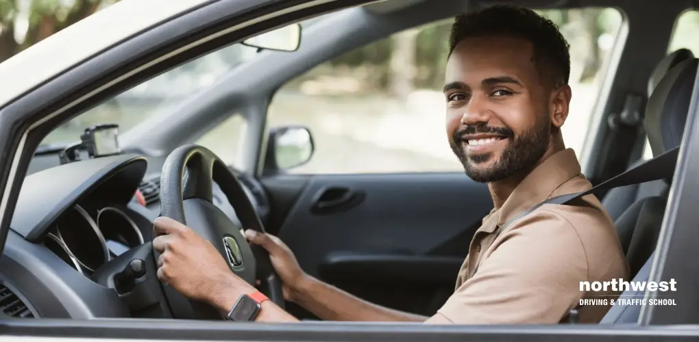 Smiling man in a car, embodying the spirit of an Active Learner at Northwest Driving & Traffic School.