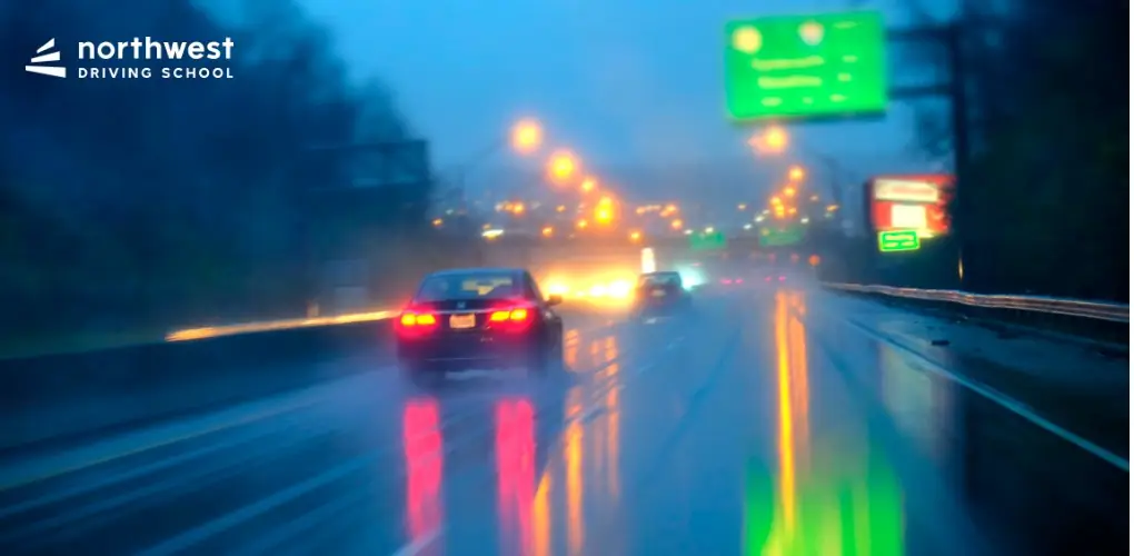 A car drives on a wet highway in heavy rain, illustrating tips from How To Drive In Stormy Weather.