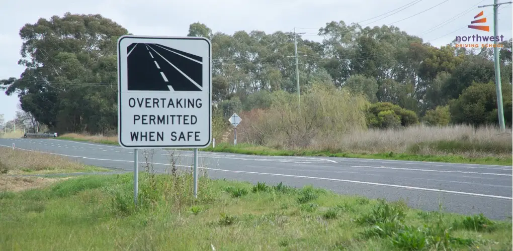 A road sign reads Overtaking Permitted When Safe, guiding drivers on how to overtake safely.