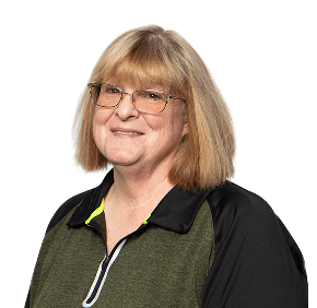 Smiling woman with shoulder-length blonde hair, wearing glasses and a black and green athletic shirt.