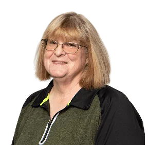 Smiling woman with shoulder-length blonde hair, wearing glasses and a black and green athletic shirt.