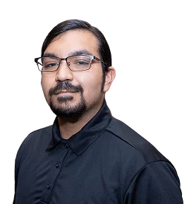 A man with glasses and a beard wears a black polo shirt, posing against a plain black background.