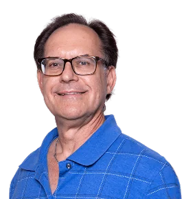 Smiling man with glasses wearing a blue polo shirt, against a plain background.
