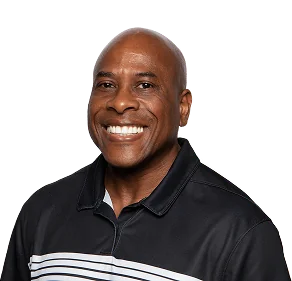 Smiling man in a black polo shirt with white stripes, against a plain background.