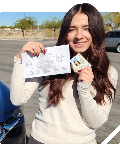 A woman smiles while holding a document and an ID card in a parking lot, with cars and trees in the background.